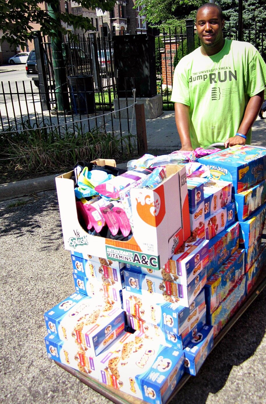 Xavier of Northwestern University Settlement House carts DMC's donation.